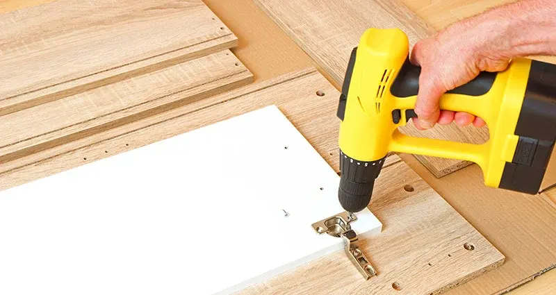 Reassembling a furniture with screw driver to pack and ready to be relocated